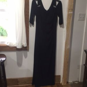 Navy blue formal dress exposes shoulder